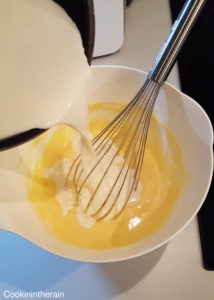 ajout du lait vanillé tiède sur les jaunes blanchis
